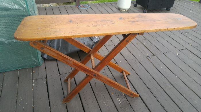 Vintage wooden ironing board and we have several antique irons as well!
