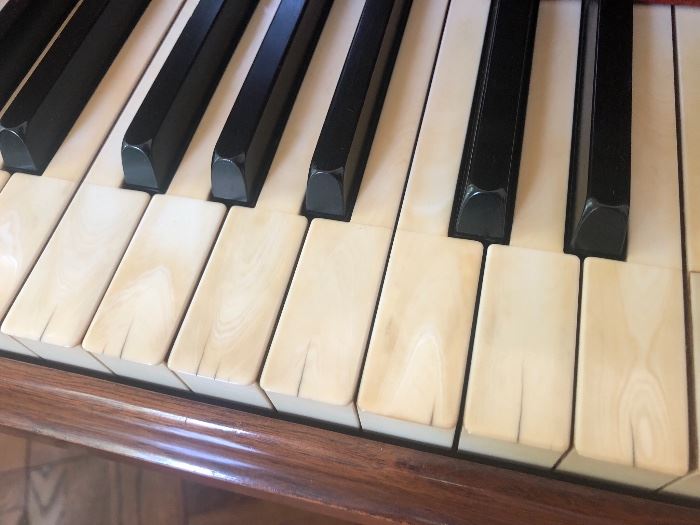 The original ivory keys have some discoloration and hairline cracks