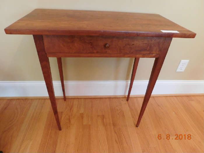 Circa 1850 cherry table w/ tapered legs.