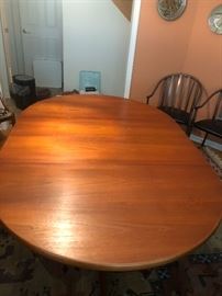 Mid Century Modern Teak Dining Table has table pads and 2 extensions 