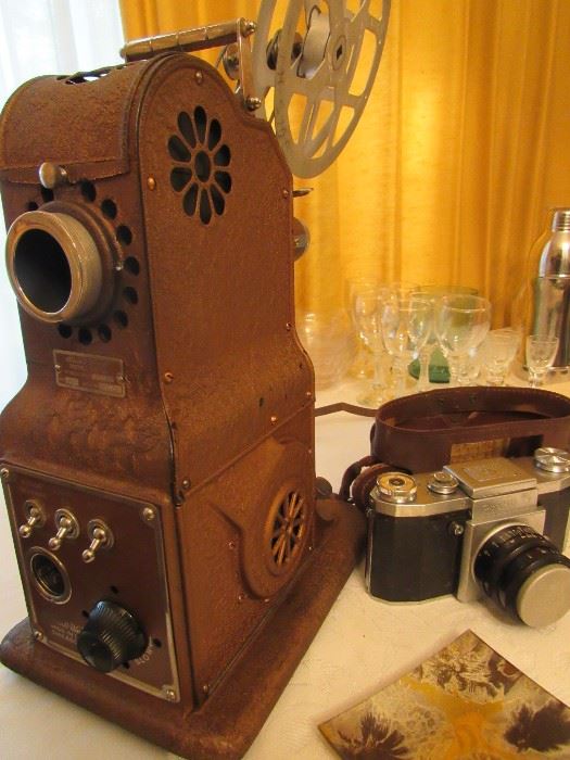 Vintage Praktica 35mm Camera, Vintage Stewart Warner Film Projector (in case), tripods, screens, etc.