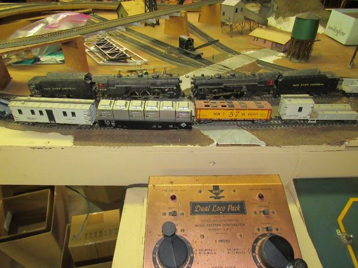 Vintage Lionel Train Set and Village with a wide variety of cars, two engines, pieces and parts
