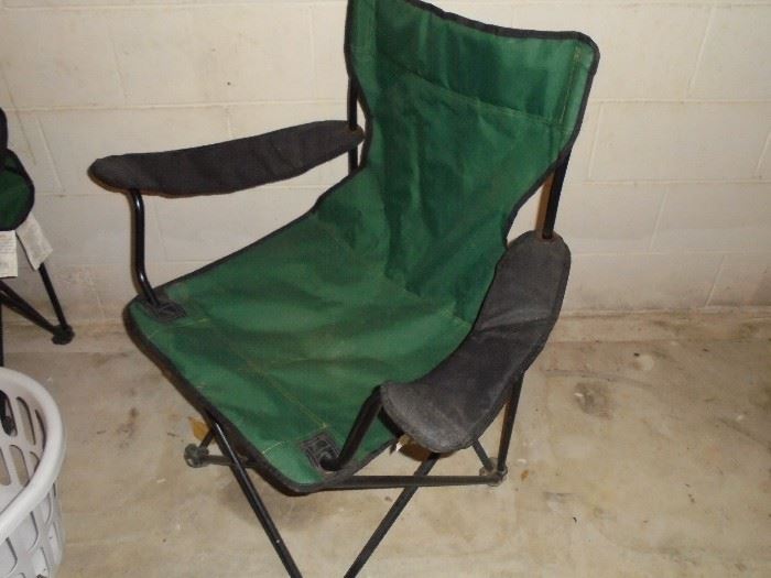 1 of 2 green folding chairs