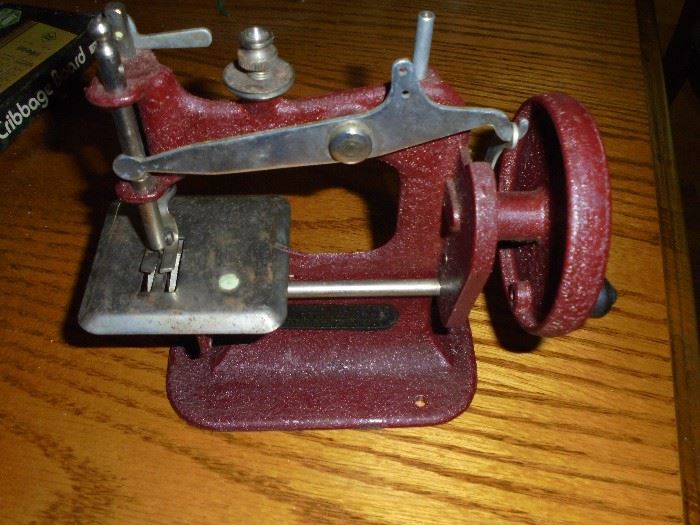 Mid-century child's sewing machine toy  (works, cast iron, made in Calif, with real needle, missing thread)