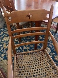 The chairs feature an unusual leather strap weave (similar to a snow-shoe) and “rabbit ear” accents