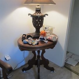 Antique table; contemporary lamp; some old dolls