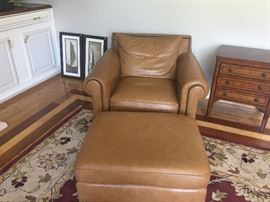 One of two Benhardt leather arm chairs with ottomans