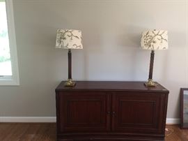 2 door credenza with pair of brass and wood columnar lamps with floral stitched shades