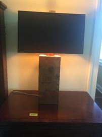 One of a pair of Copper leaf  lamps with black shades lined in metallic gold