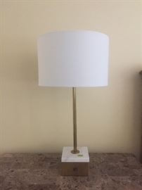 One of a pair of gold contemporary lamps with marble on gold bases. These have computer and charger ports in them.