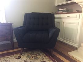 One of a pair of Coaster brand contemporary black arm chairs