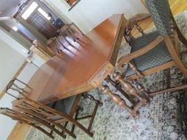 Dinning Room table has 2 leaves (in now) and 6 chairs, one is a captain chair.