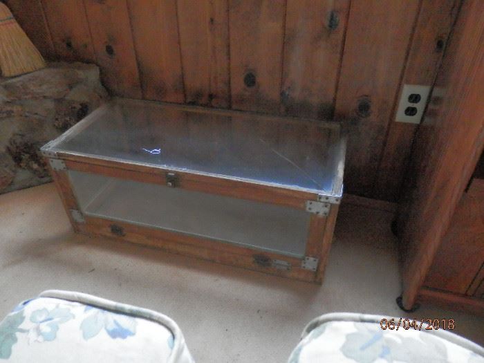 Glass "footlocker" style coffee table....top glass has one crack