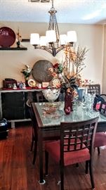 Beautiful dining table that extends to twice the size, frosted cube  glass top and the chairs have terra cotta colored removable covers.