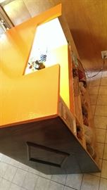 Storage and work areas with light/outlet behind the bar
