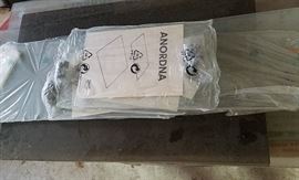 Stack of glass (clear, frosted, and smoked) for shelves and cabinet doors....some still in original packaging