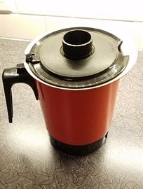 red metal coffee pot with base and all attachments