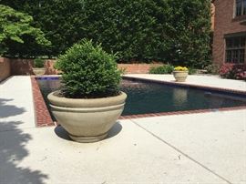 Large concrete planters. There are FOUR! One has a crack in it, three are in perfect condition. 