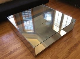 LITT Stainless steel coffee table with transparent glass.