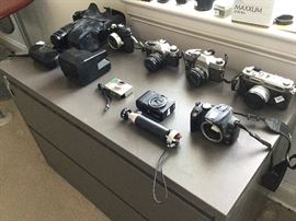 Assortment of vintage cameras: Minolta, Polaroid, canon, Nikonos, Yahika, 