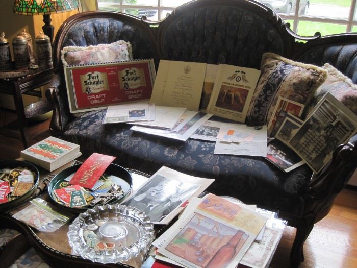 settee & coffee table loaded with Utica Club items