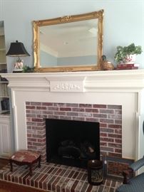 Gold framed mirror on the  office/parlor/library  fireplace mantle