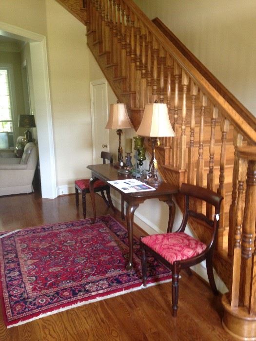 Lovely entry with an entry/sofa table & beautiful lamps, rug, and chairs