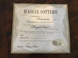 The formal dress is complete with the Maggie Sorrero certificate of authenticity. 