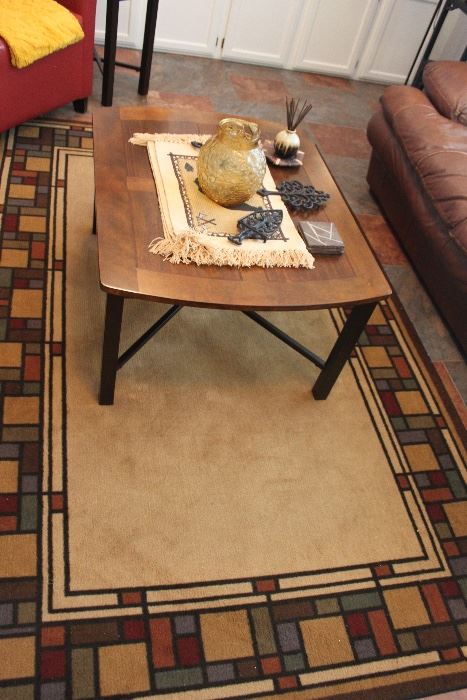 coffee table, mid century pitcher, cast iron trivets, geometric rug