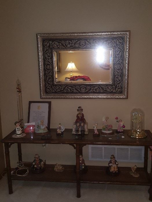 Including frame, 29" tall by 40" wide beveled glass mirror; sofa table; figurines and collectibles.