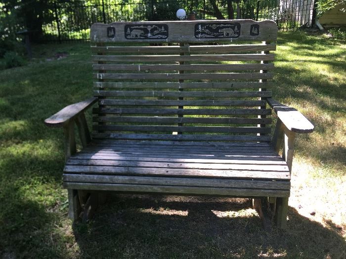 A bench for two-on the back is a bear and farm