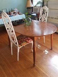 Table with leaf (not shown). Painted white iron chairs