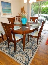 Walnut dining table with two leaves. Chairs sold as set of 4 separately.