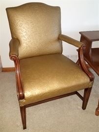 Vintage chair with gold vinyl upholstery.