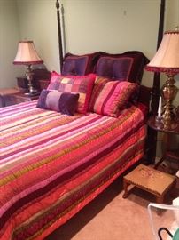 Lovely 4-poster bed; matching lamps; colorful bedding.