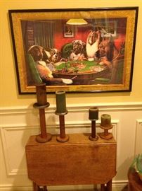This iconic picture features some very smart dogs playing cards; small antique drop leaf table; vintage industrial wood spool candle holders