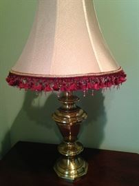 One of two  lamps with colorful fringe