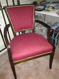 One of two red (leopard print) upholstered chairs.