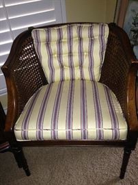 One of two caned barrel back and striped upholstered chairs  