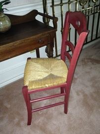 Antique red chair with rush seat