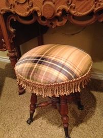 Antique stool with plaid fabric and fringe