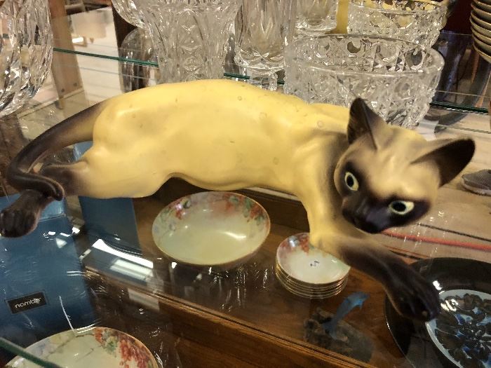And this curious Siamese porcelain cat from Japan is curious and cute lounging about