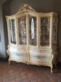 Italian china cabinet with glass shelves and Lighting along with mirror back