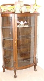 Oak bowed glass curio cabinet with paw feet