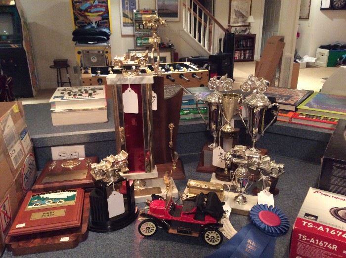 This home has a variety of car related items from these trophies to magazines and art