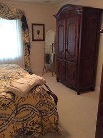 Guestroom with beautiful armoire, chest, nightstands, crystal lamps and brass standing mirror