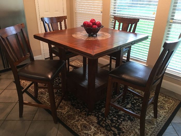 Nice Pub or bar style dining table & 4 chairs. In great condition! Table has marble lazy susan in the center and drawer at the base. 