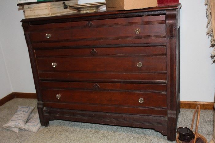Three drawer antique chest with glass knobs