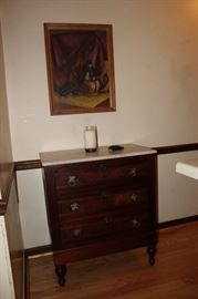 Three drawer marble top stand with brass drawer pulls indicative of Federal era