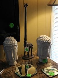 2 more Oriental head statues with metal giraffe.
